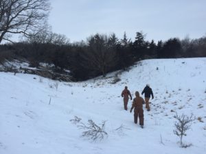 Farmers on a Land Walk in northwest Iowa, finding ecological solutions to issues of water flow running off of a row crop field, the removal of monoculture cedars in a pasture, and designing resilient wind protection for people, crops, and cattle.