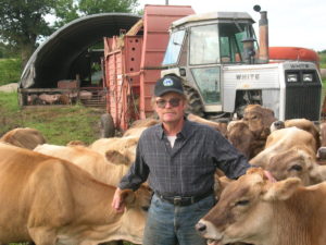 John Gilbert with Gibralter Farms' herd of brown swiss dairy cows.